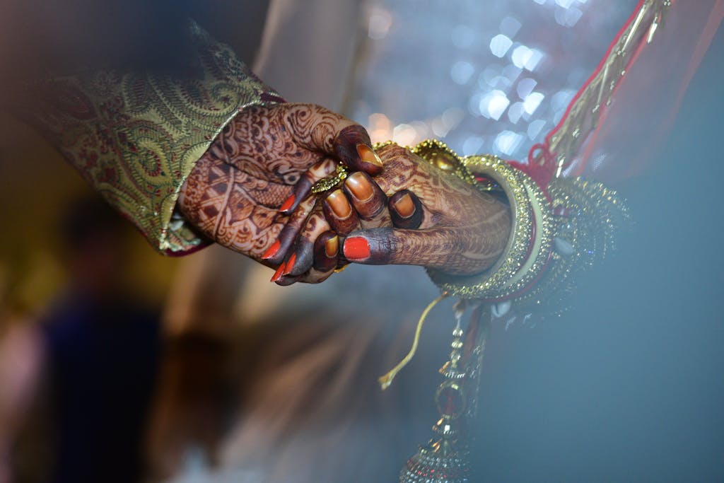 Bride and Groom holding Hands representing a key moment in Indian Weddings